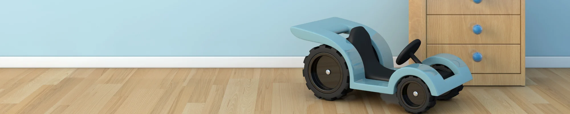 Blue car toy in kid's room with natural stained waterproof flooring