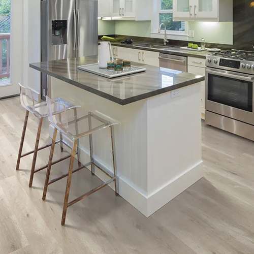 Natural stained laminate floors installed in bright kitchen