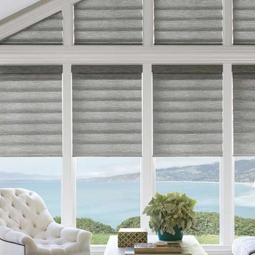 Custom pleated blinds installed in peaked windows